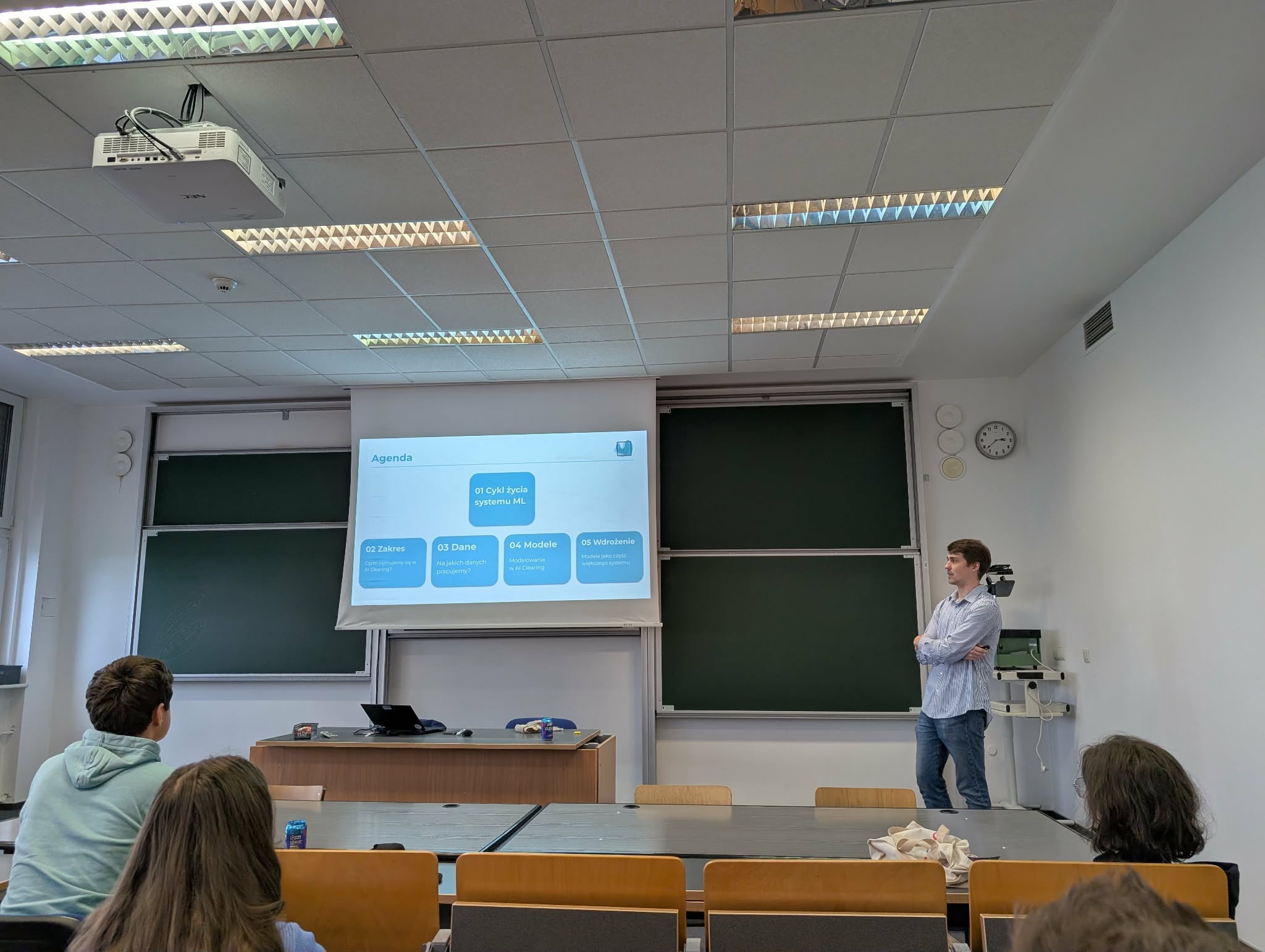 AI Clearing speaker presenting the talk agenda