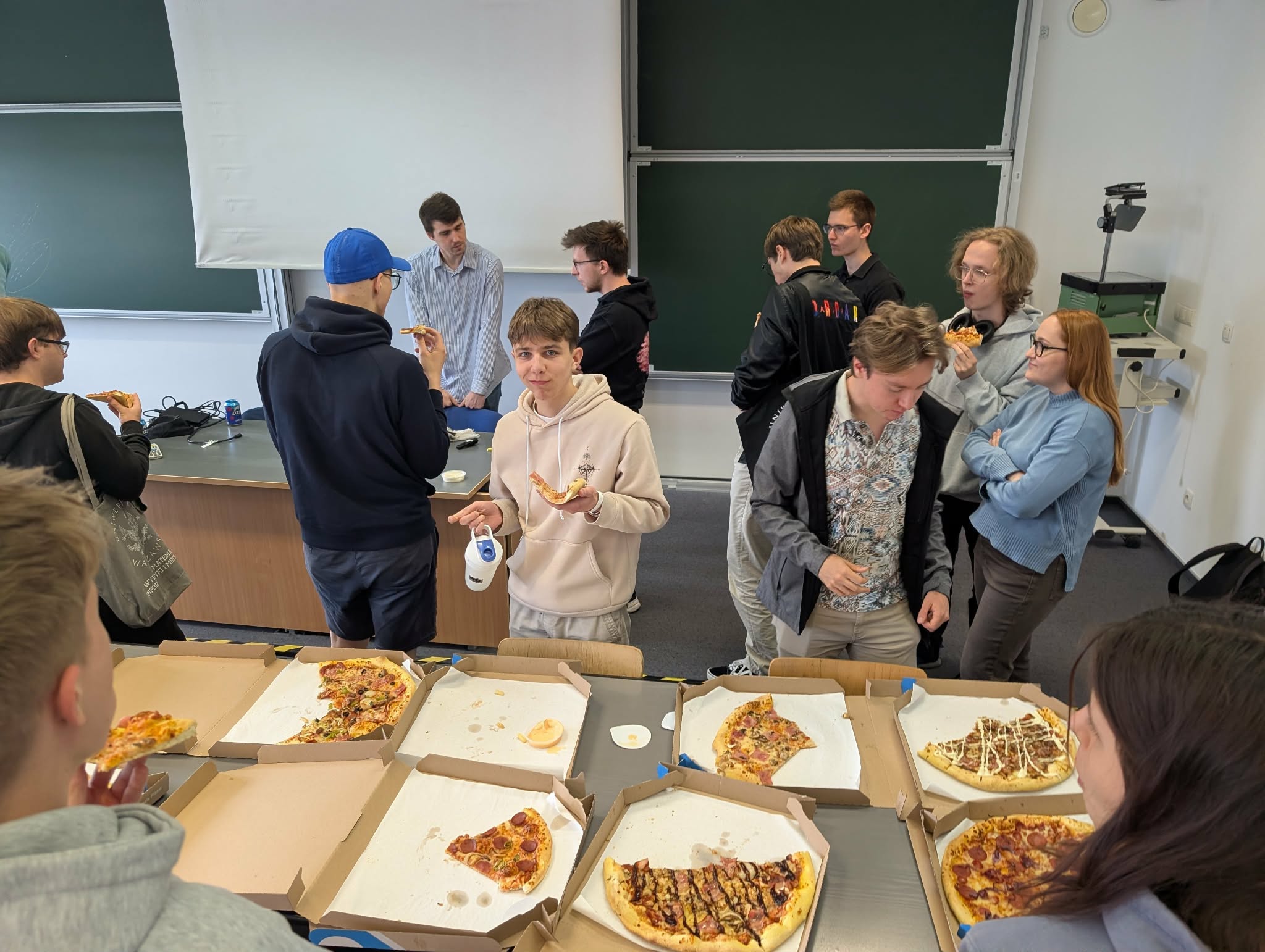 Attendees chatting over pizza after the talk